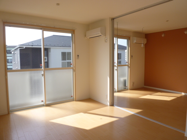 Living and room. It is a photograph of another room