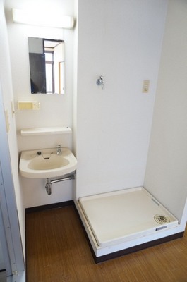 Washroom. Washing machine in the room and there washbasin