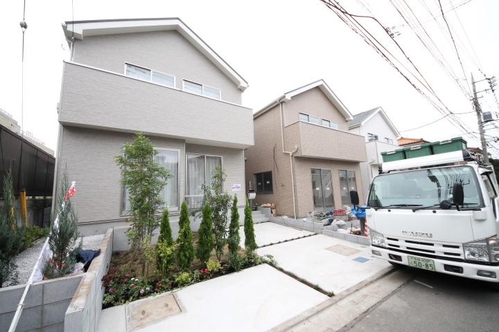 Local appearance photo. Newly built condominiums with planting. Outer wall has adopted siding.