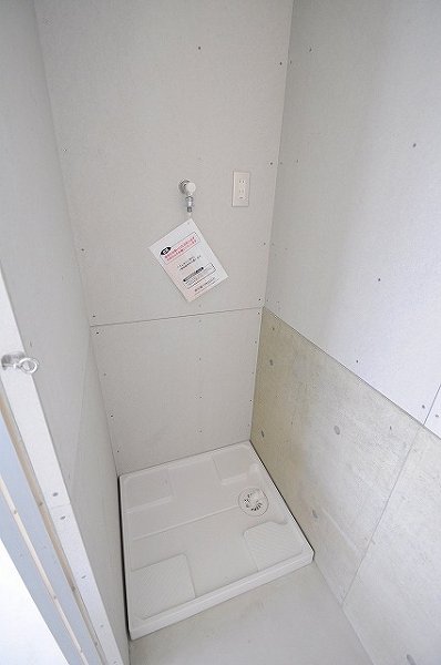 Other room space. Washing machine in the room