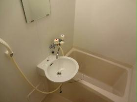 Bath. There is a wash basin in the bathroom.