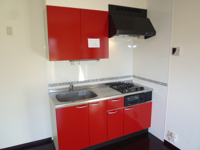 Kitchen. It is a nice bright red kitchen