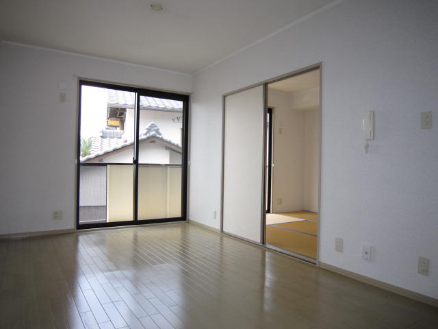 Living and room. Living is. (Taken from the kitchen side)