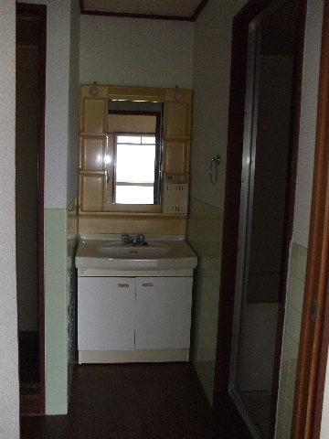 Washroom. It also attached wash basin.