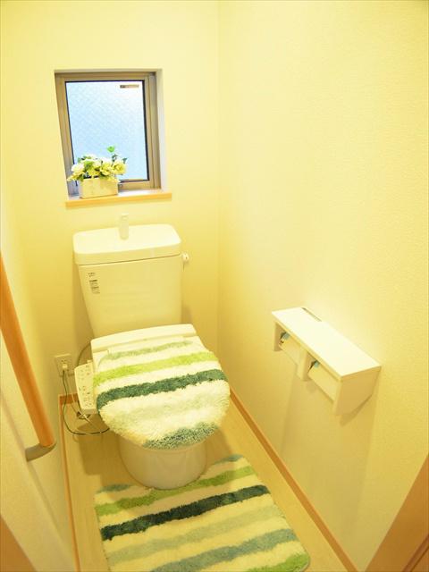 Toilet. Toilet with a handrail