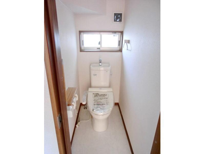 Toilet. With a bright small window, It is clean and can look up to every nook and corner. Building 2 toilet