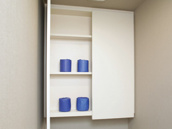 Toilet.  [Hanging cupboard] Taking advantage of the space from the toilet back of the waist-to-ceiling, We established a convenient hanging cupboard in such storage of paper such.