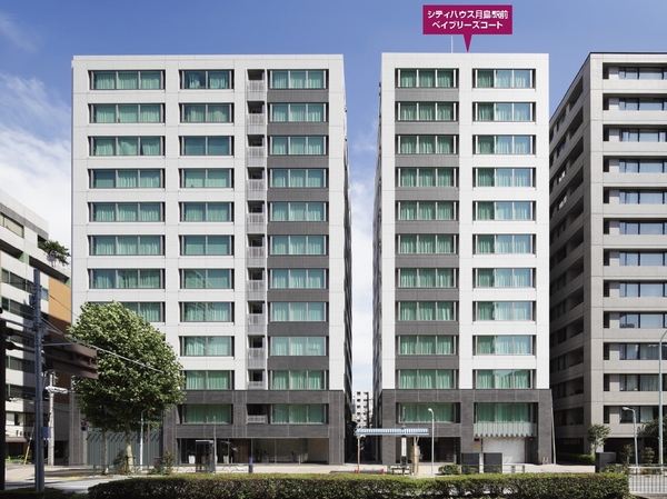 Building structure. "Tsukishima Station" bus stop is imminent, Building appearance shine in blue sky