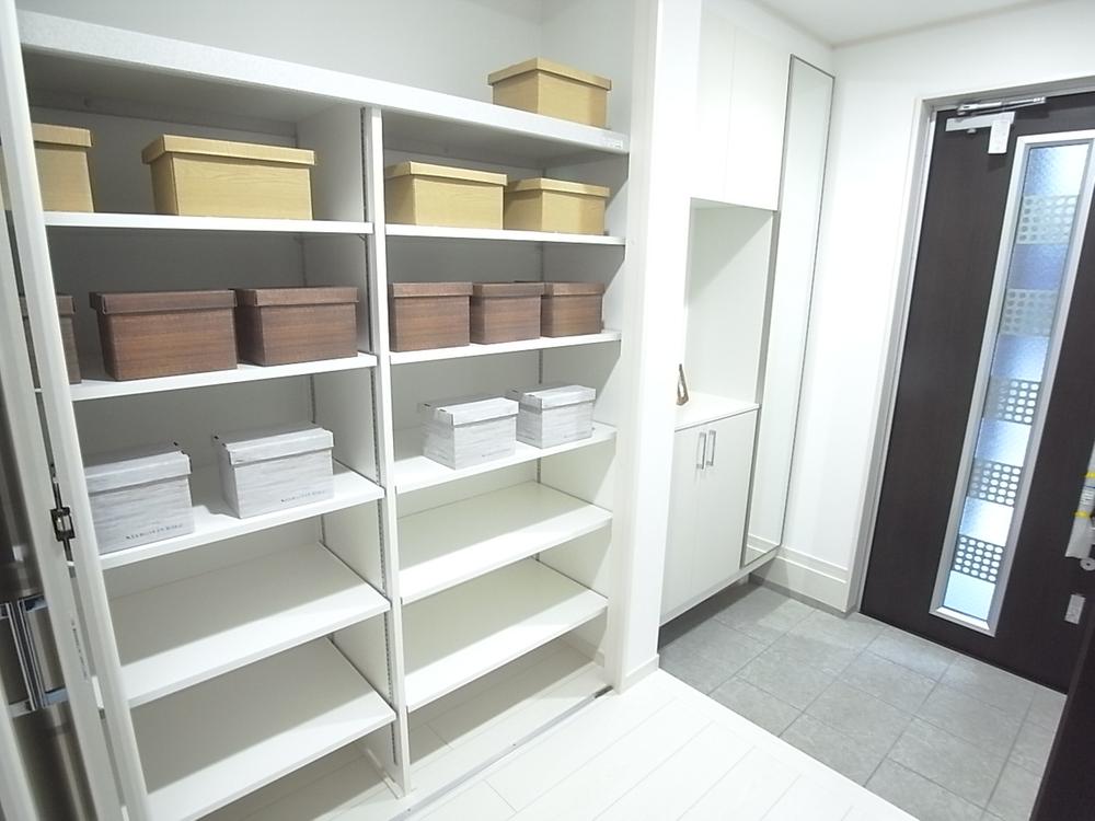 Entrance. It is the entrance of the model house D Building. Storage capacity plenty.