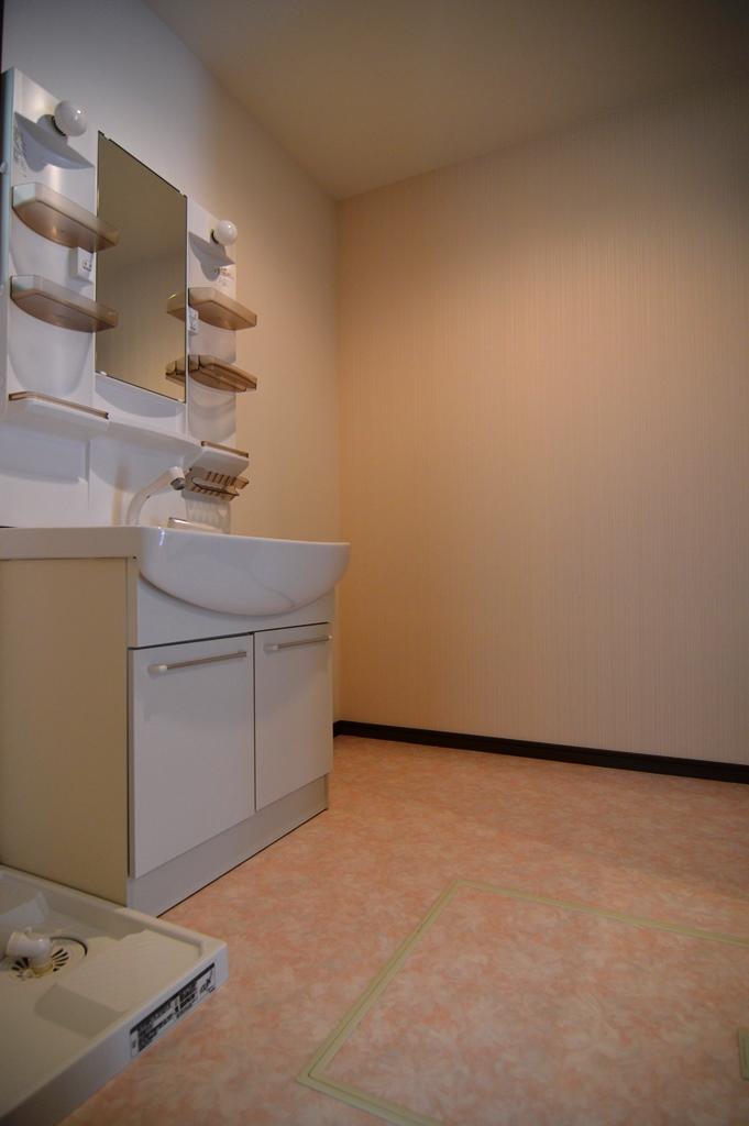 Wash basin, toilet.  [Photo C-1 Building] Washroom of cushion floor is refreshing pink.