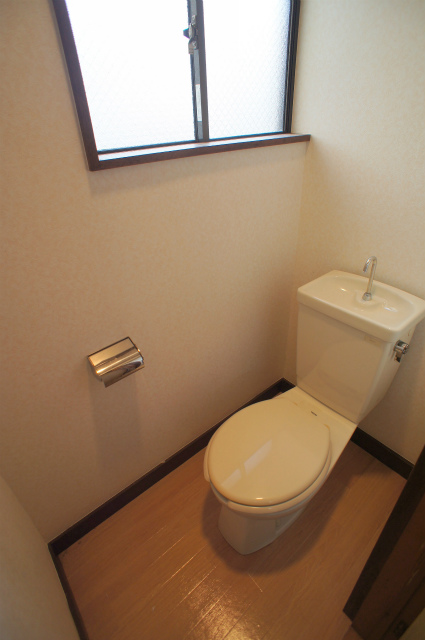 Toilet. It is a toilet that is with a small window