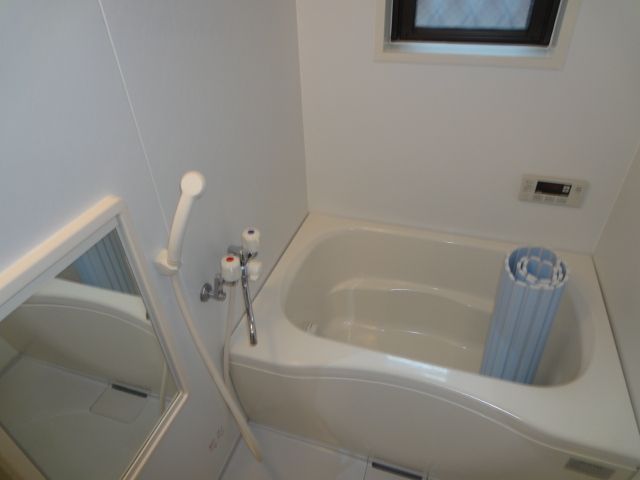 Bath. Bright is equipped with a window.