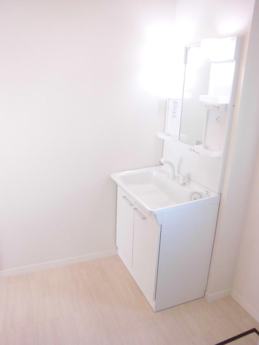 Wash basin, toilet. It is the washroom