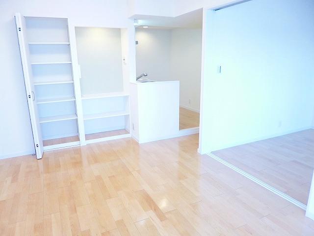 Living. Living room with storage shelves.