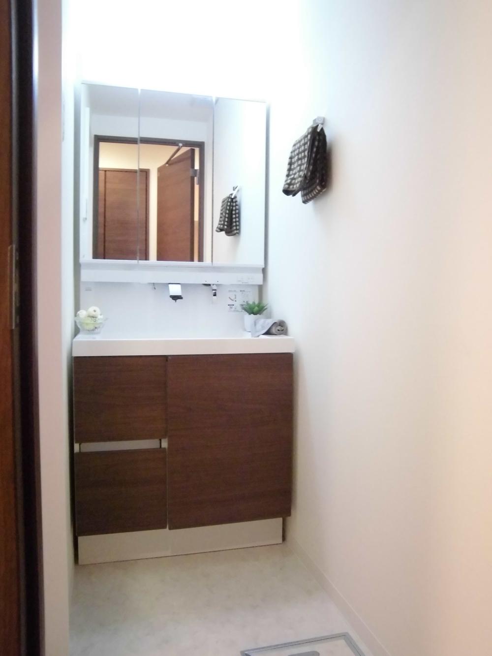 Wash basin, toilet. It is the washroom