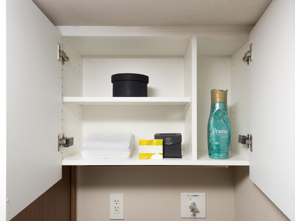 Bathing-wash room.  [Laundry hanging cupboard] Established the efficient use and hanging cupboard the upper dead space of the washing machine Storage. Bar also installed that can be temporarily placed the hanger.