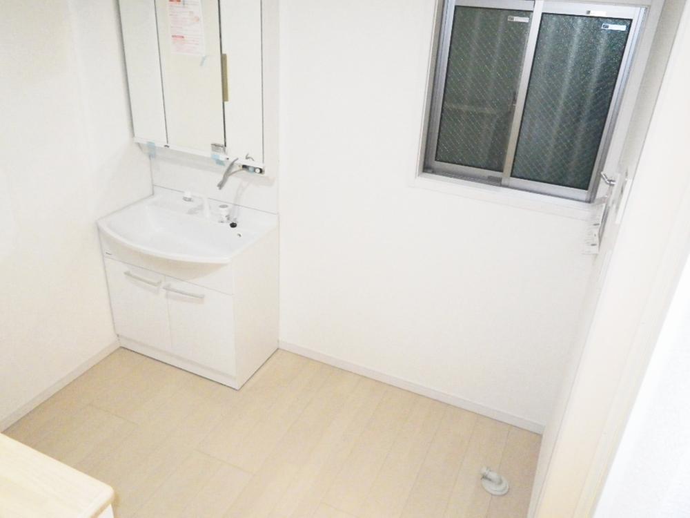 Wash basin, toilet. It is quite spacious washroom.