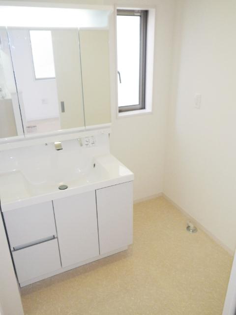 Wash basin, toilet. It is bright and comfortable washroom with a window