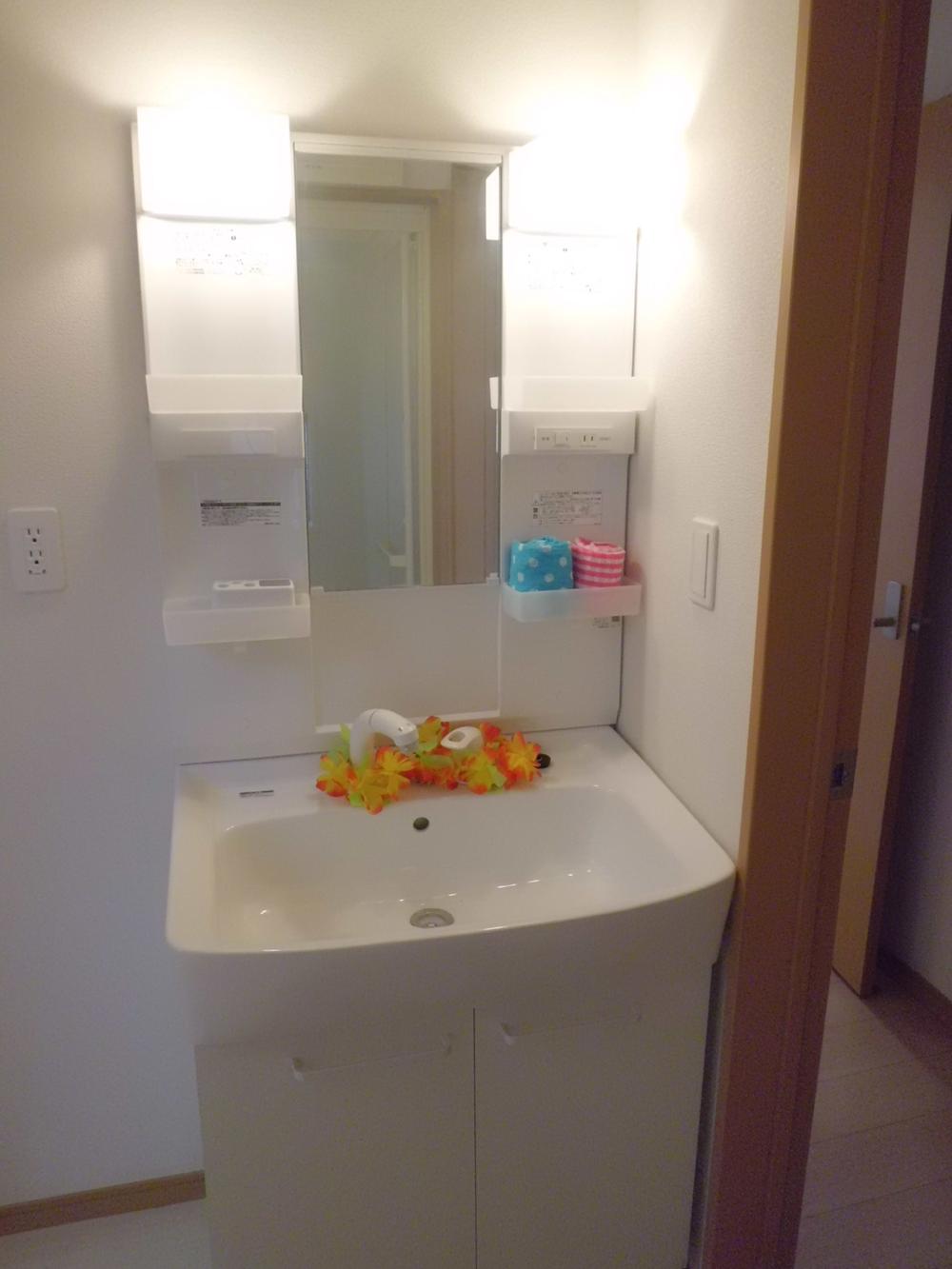 Wash basin, toilet. The photograph is an image. 