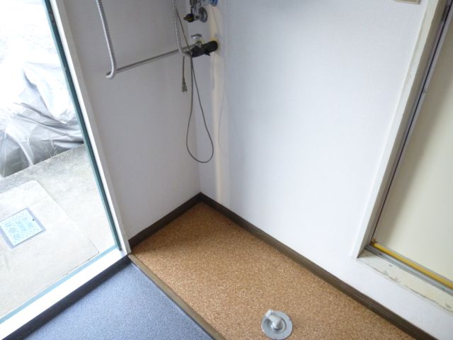 Other room space. Entrance next to a washing machine inside the yard.