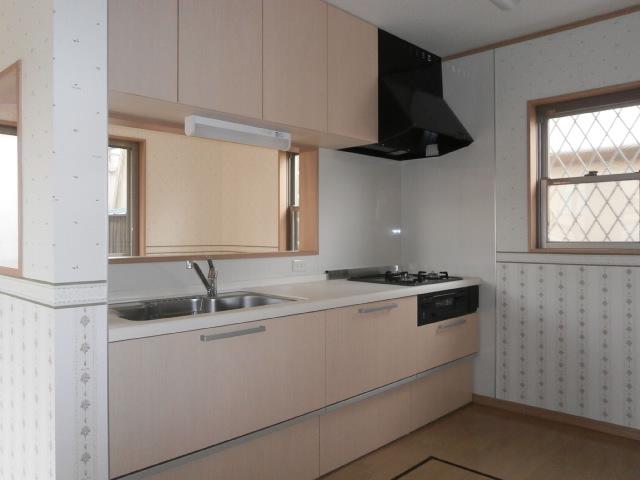 Kitchen. Soft colors of the kitchen, Cleaning of the easy three-necked gas stove