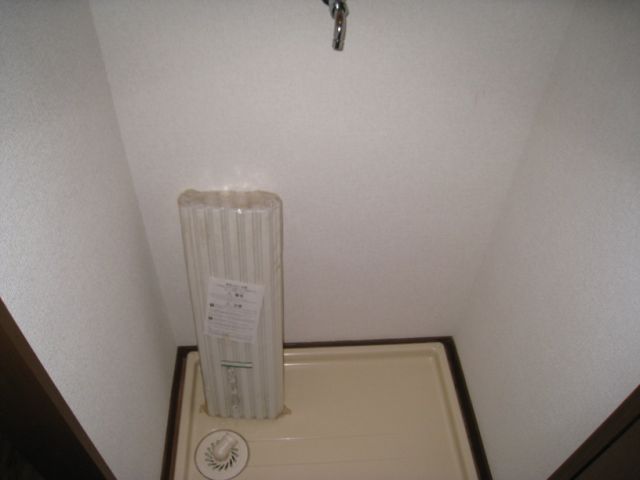 Other room space. Washing machine storage is located in a room.