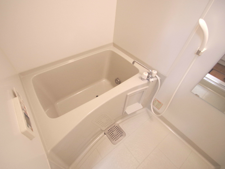 Bath. Same building, It is a photograph of the same floor plan of the room.