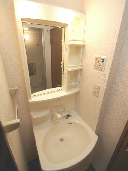 Washroom. Same building, It is a photograph of the same floor plan of the room.