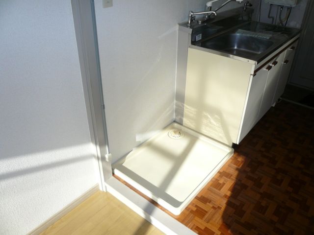 Other room space. Washing machine in the room