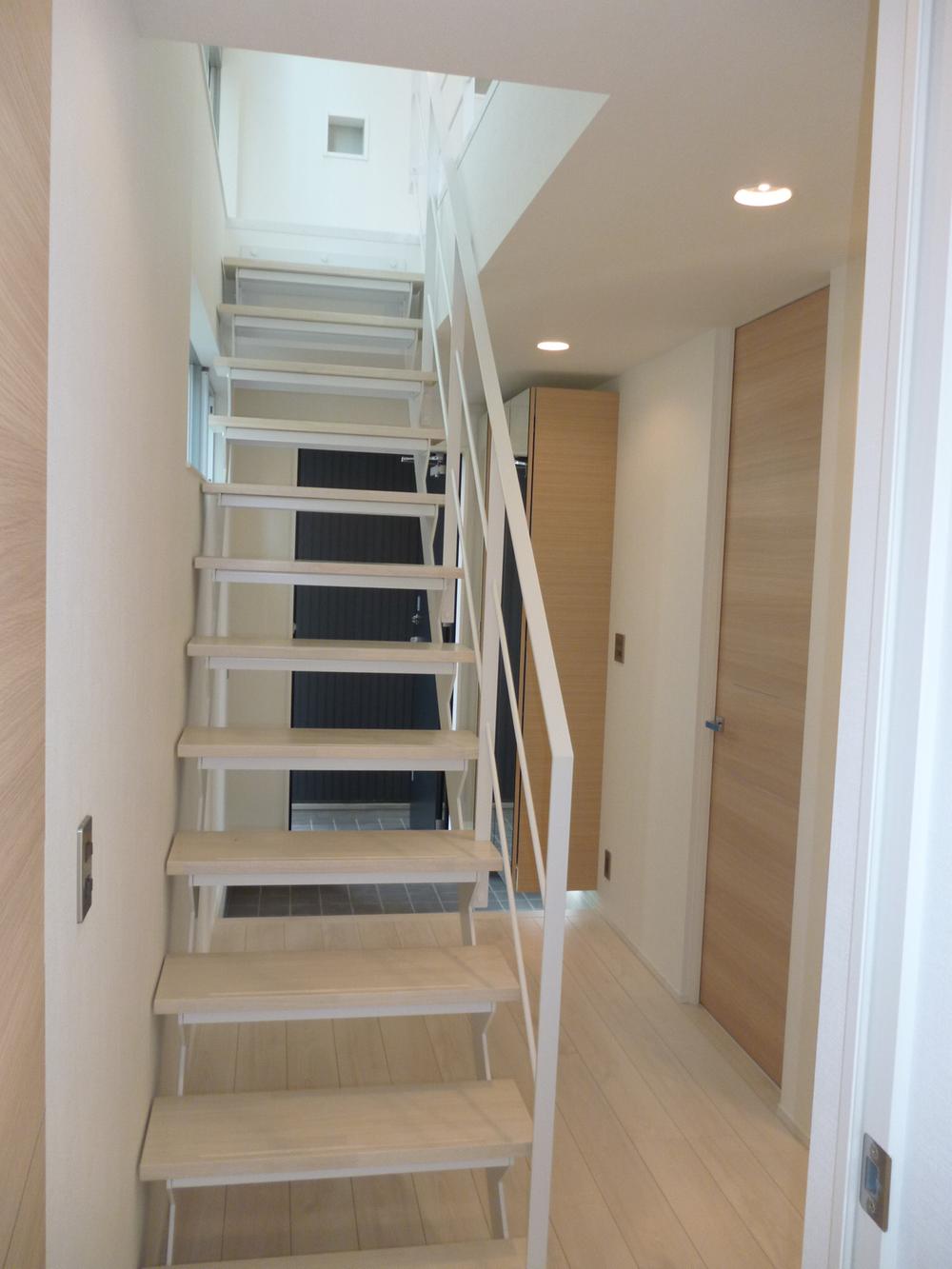 Entrance. Skeleton stairs (interior stairs) has showed neat and wide space in the entrance hall