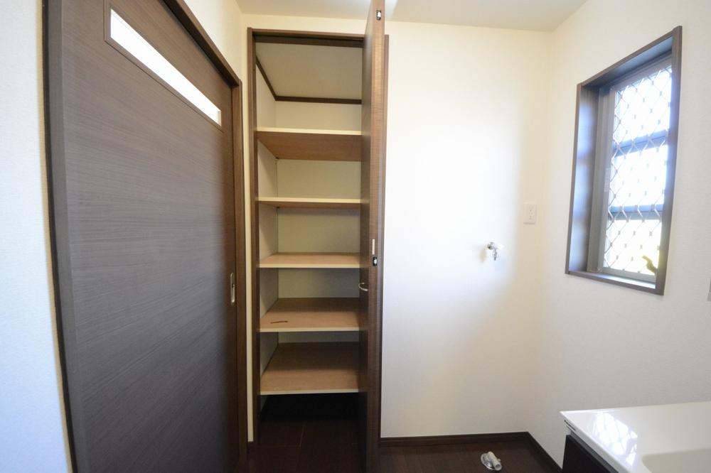 Wash basin, toilet. There is also a put washroom housing the detergent stock and towels.