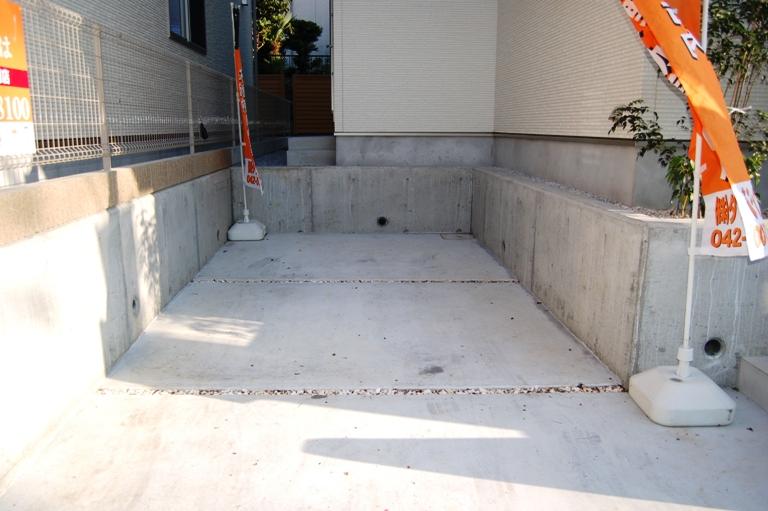 Parking lot. There is one minute car space. The slit was provided with the accent on color crushed stone.