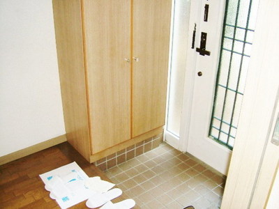 Entrance. Front door storage cupboard