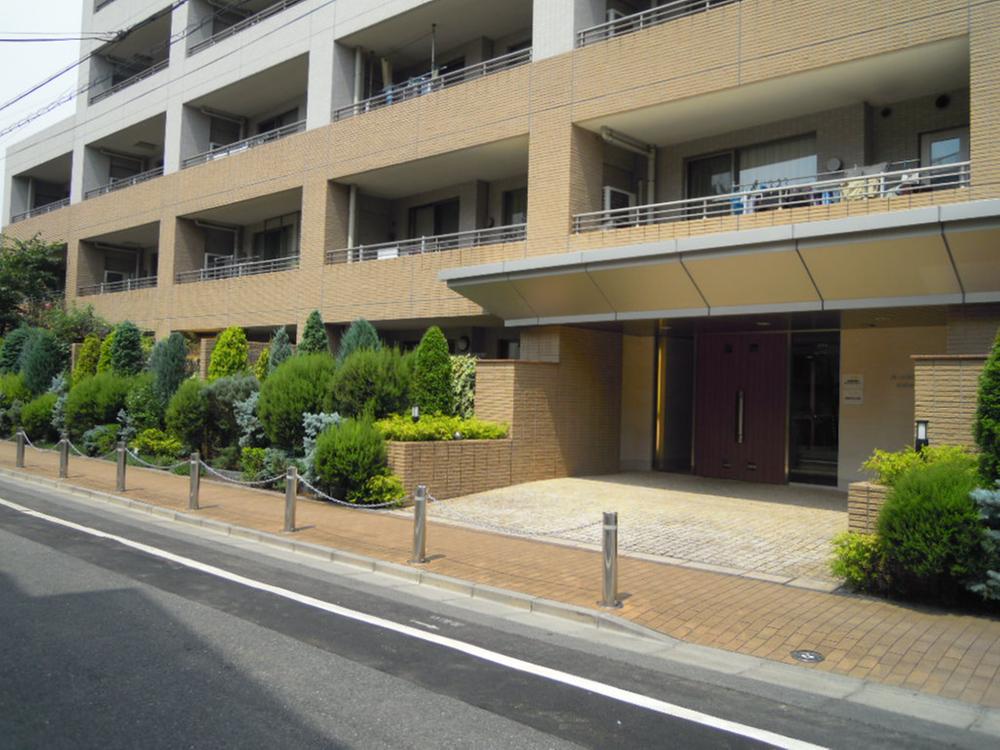 Local appearance photo. Local (July 2013) Shooting Paved front road. Bright entrance is surrounded by planting.
