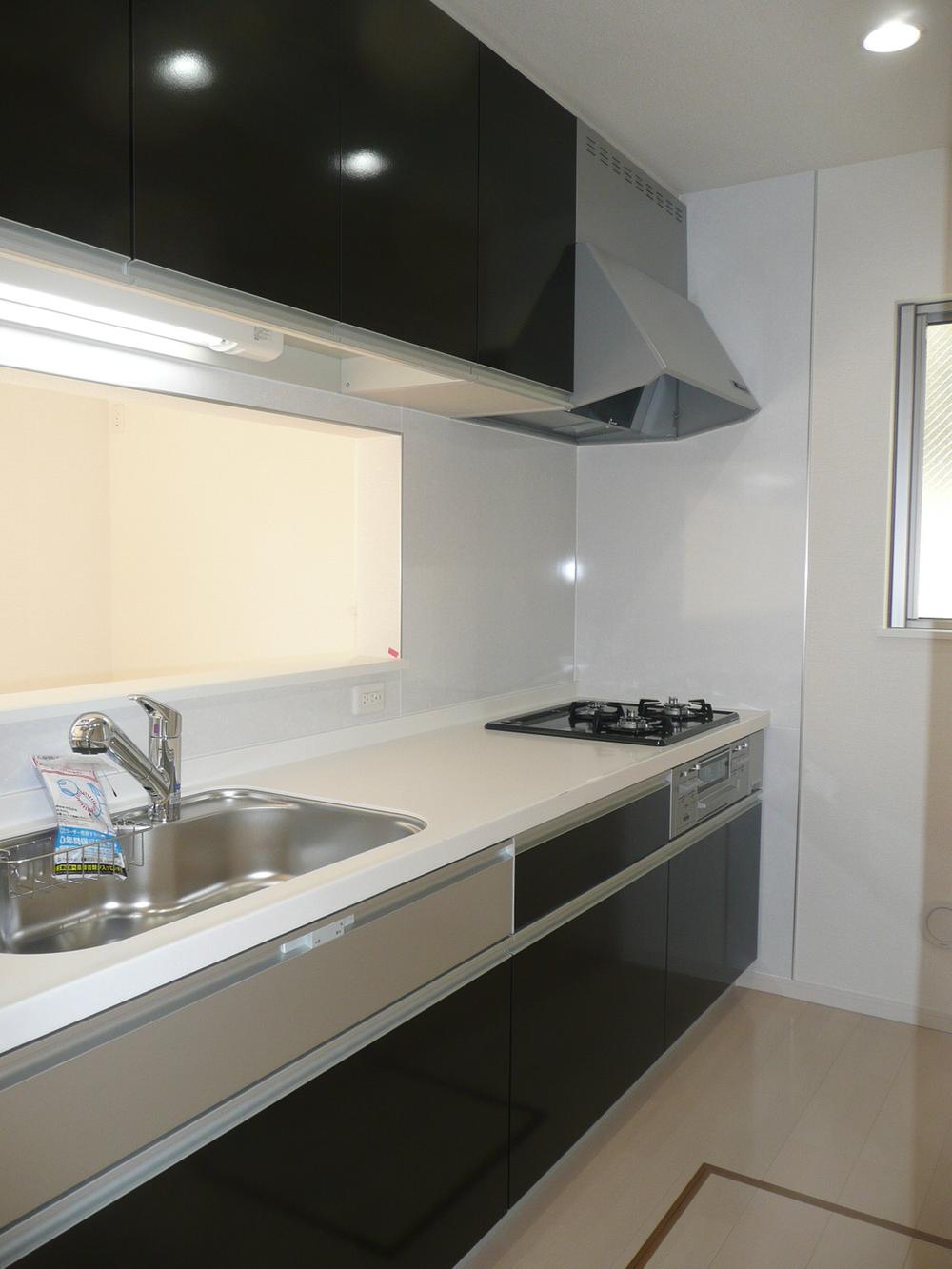 Kitchen. There is a kitchen dignified tones and dark brown.