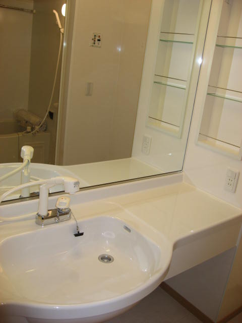 Washroom. With spacious basin counter the entire surface of the mirror-clad!