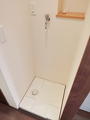 Washroom. Washing machine in the room