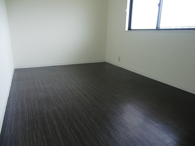 Other room space. There is a window on the east side.