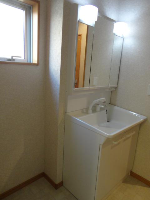 Wash basin, toilet. Bright washroom! 