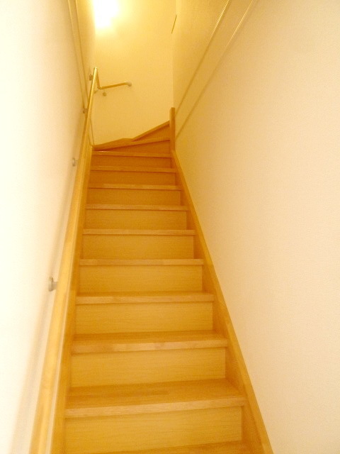 Other room space. Bright indoor stairs with handrail