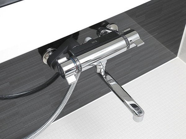 Bathing-wash room.  [Mixing faucet with thermostat] In mixing faucet with a temperature adjustment function, It can be adjusted to the temperature of the preference.