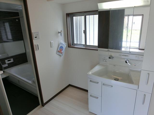 Wash basin, toilet. It is the washroom.