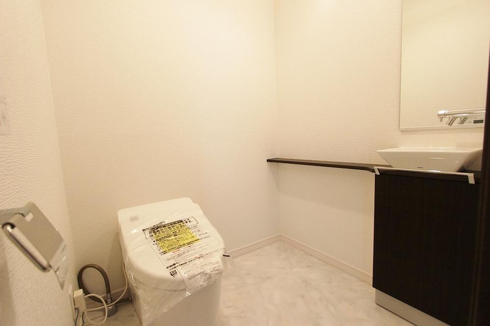 Toilet. It is a toilet with a wash basin counter
