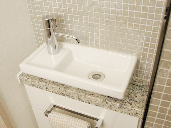 Bathing-wash room.  [Hand wash counter] Installed hand washing counter of the square design to produce a space of the room. Also features a towel rail.