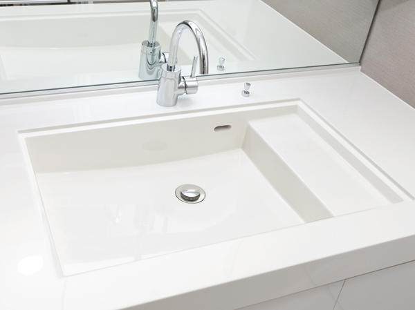 Bathing-wash room.  [Wash bowl (with step-integrated)] Counter and bowl in the integrally molded with no easy seam of care, Beautiful luster organic glass-based new material specifications. A bowl of linear square form, Directing the urban space. Within the wash bowl, Set up a space that put wet cups and soap, etc..