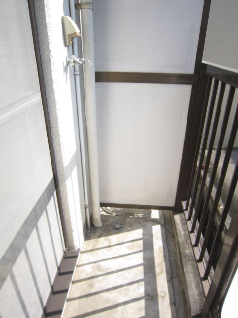 Balcony. Washing machine storage is located in the veranda