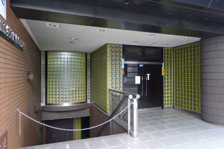 Building appearance. Unique entrance yellow glass blocks.
