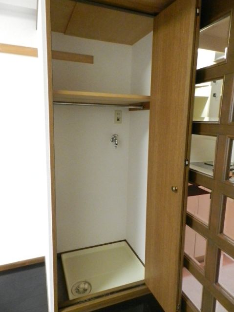 Other room space. Washing machine storage is located in the room