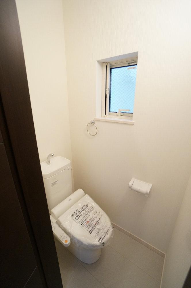 Toilet. Toilet is with a bidet. It is a small window also happy