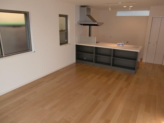 Living. We look at the living room from the south. Cafe style kitchen has become an accent.